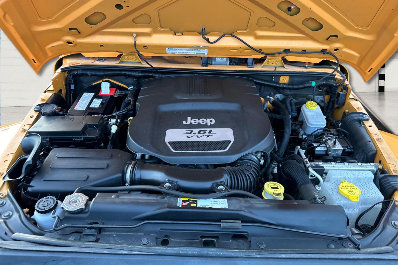 2012 Yellow Jeep Wrangler Unlimited Sahara 4WD (1C4BJWEG3CL) with an 3.6L V6 DOHC 24V FFV engine, Automatic, 5-Spd transmission, located at 7755 State Street, Midvale, UT, 84047, (801) 753-9063, 40.610329, -111.890656 - Photo#10