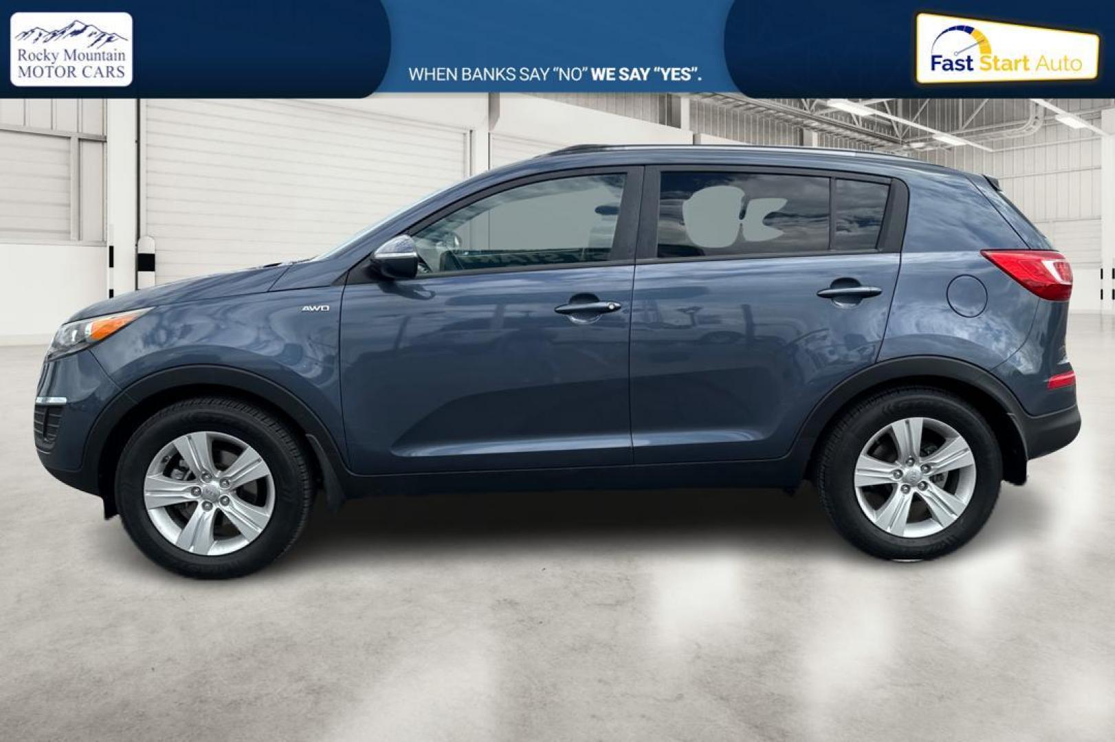 2012 Blue Kia Sportage LX AWD (KNDPBCA22C7) with an 2.4L V6 DOHC 24V engine, 6-Speed Automatic transmission, located at 344 S Washington Blvd, Ogden, UT, 84404, (801) 399-1799, 41.255482, -111.970848 - Photo#5