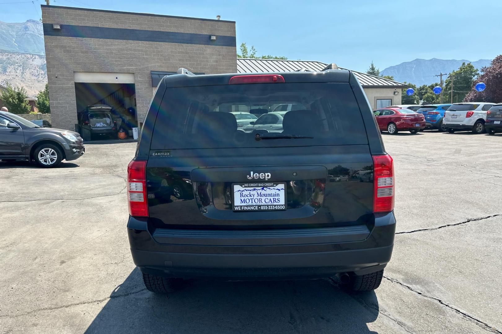 2014 Black Jeep Patriot Sport 2WD (1C4NJPBA2ED) with an 2.0L L4 DOHC 16V engine, Automatic, 6-Spd w/AutoStick transmission, located at 344 S Washington Blvd, Ogden, UT, 84404, (801) 399-1799, 41.255482, -111.970848 - Photo#3