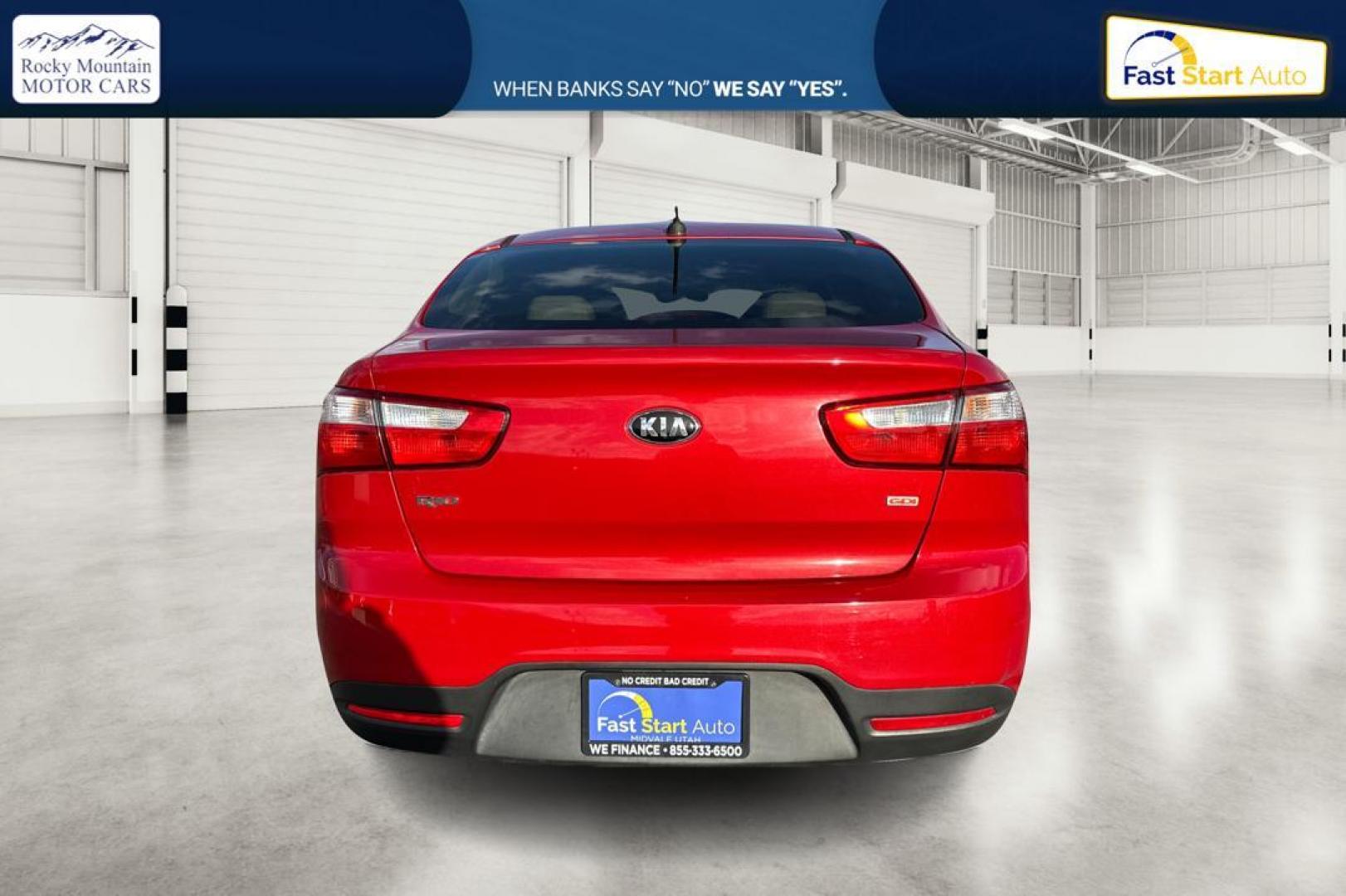 2014 Red Kia Rio LX (KNADM4A35E6) with an 1.6L L4 DOHC 16V engine, Automatic, 6-Spd transmission, located at 767 S State Road, Pleasant Grove, UT, 84062, (801) 785-1058, 40.354839, -111.736687 - Photo#4