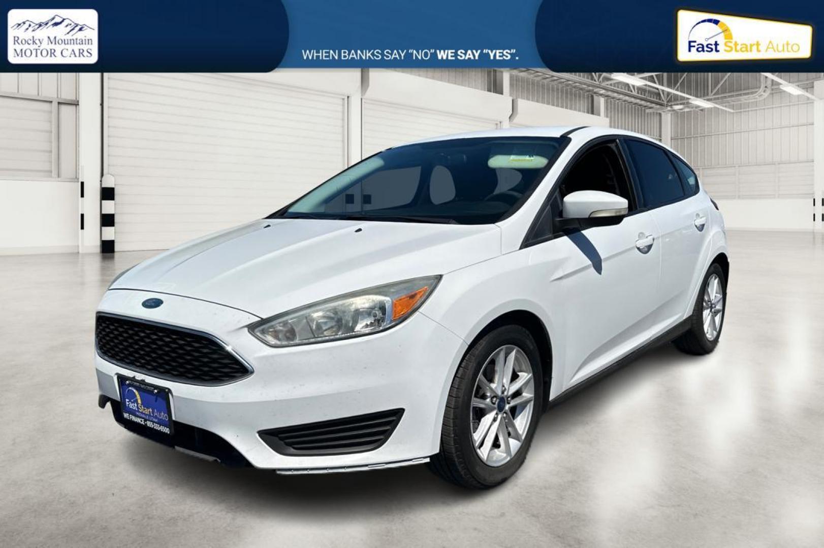 2015 White Ford Focus SE Hatch (1FADP3K23FL) with an 2.0L L4 DOHC 16V engine, 5-Speed Manual transmission, located at 7755 State Street, Midvale, UT, 84047, (801) 753-9063, 40.610329, -111.890656 - Photo#6