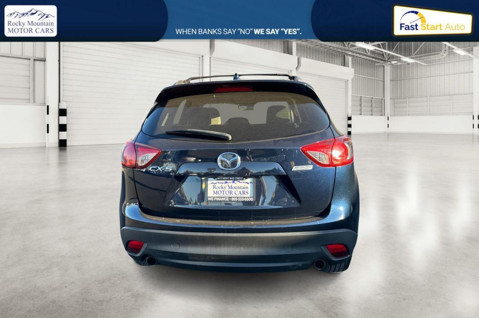 2015 Blue Mazda CX-5 Grand Touring (JM3KE2DY5F0) with an 2.5L L4 DOHC 16V engine, 6-Speed Automatic transmission, located at 344 S Washington Blvd, Ogden, UT, 84404, (801) 399-1799, 41.255482, -111.970848 - Photo#4