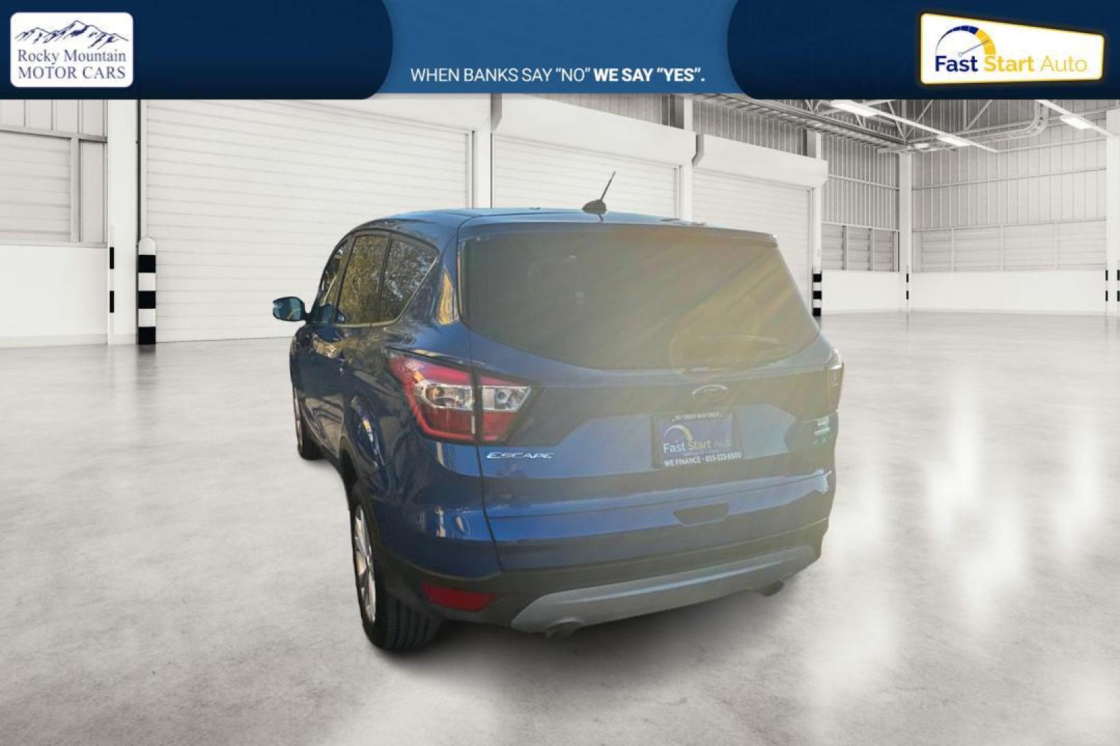 2017 Blue Ford Escape SE FWD (1FMCU0GD9HU) with an 1.5L L4 DOHC 16V engine, 6A transmission, located at 7755 State Street, Midvale, UT, 84047, (801) 753-9063, 40.610329, -111.890656 - Photo#4