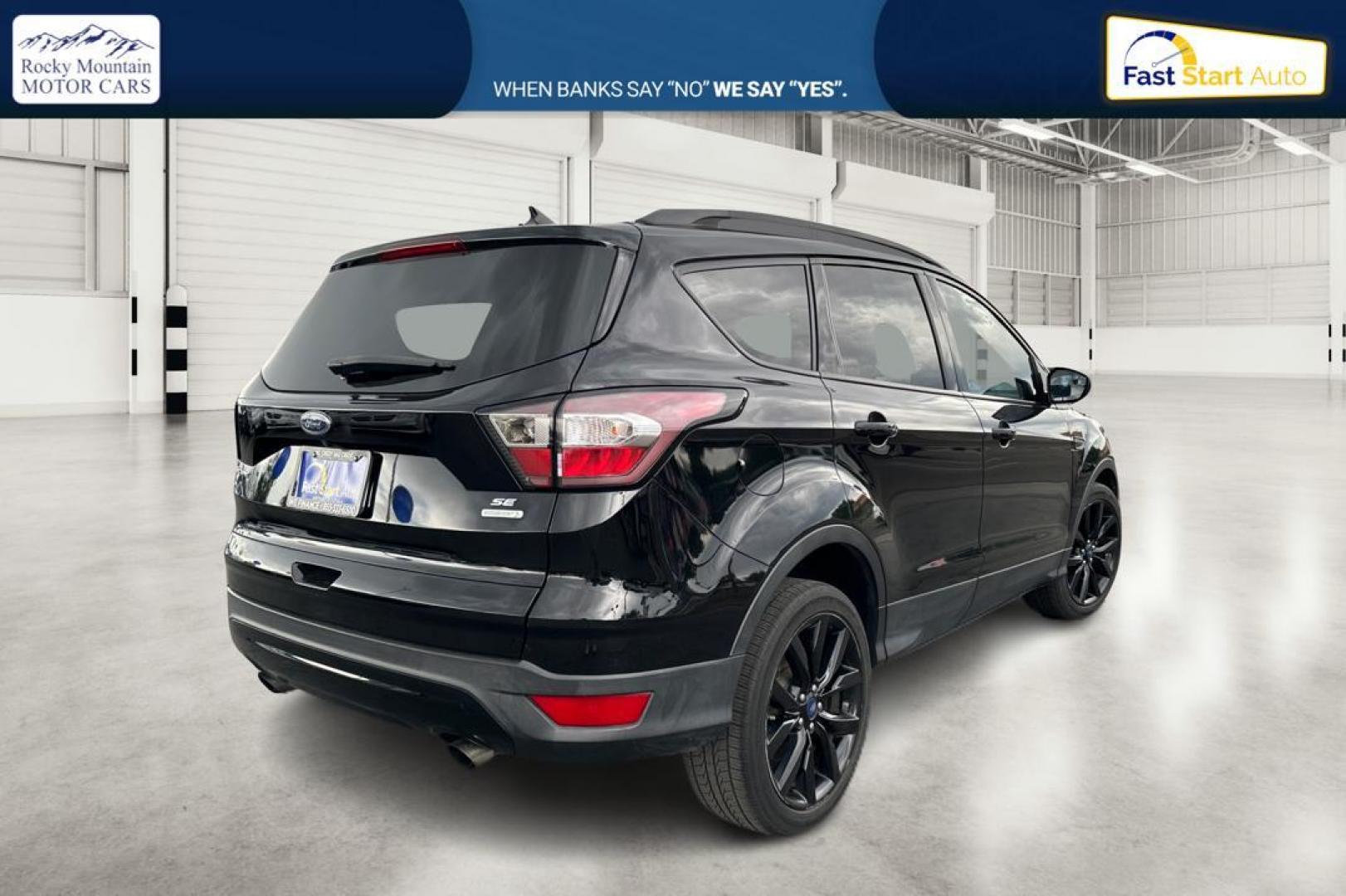 2018 Black Ford Escape SE FWD (1FMCU0GD9JU) with an 1.5L L4 DOHC 16V engine, 6A transmission, located at 7755 State Street, Midvale, UT, 84047, (801) 753-9063, 40.610329, -111.890656 - Photo#2